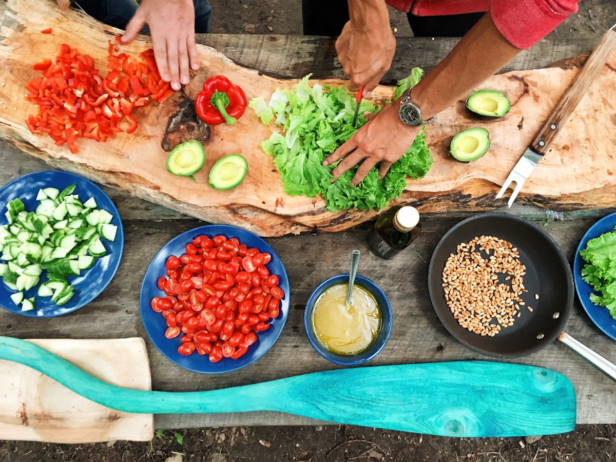 Couple cooking healthy meal — investing in a healthier lifestyle